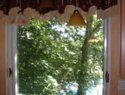 awning-window-over-kitchen-sink-with-window-drape-300x205